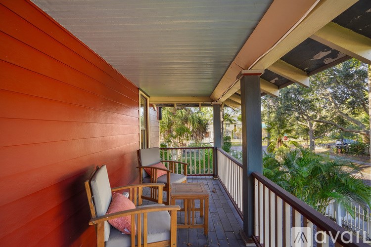 A balcony with a table and chairs.