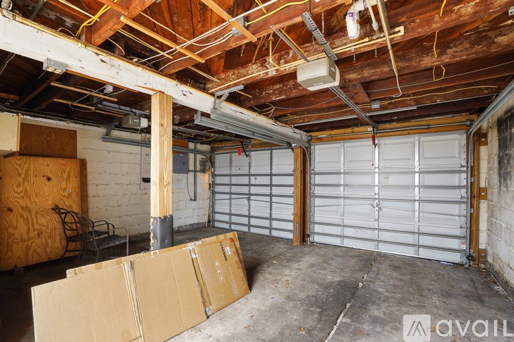 A garage with a white door and a wooden ceiling.