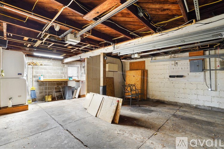 A room with a white refrigerator and a wooden door.
