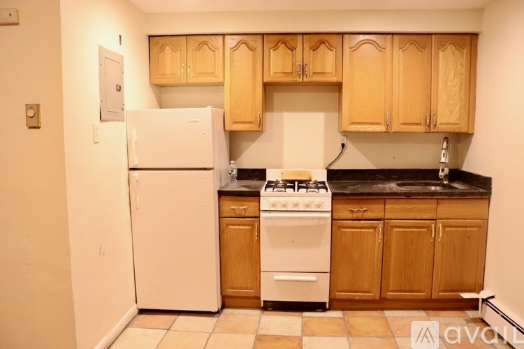 A kitchen with a white refrigerator and a white stove top oven.