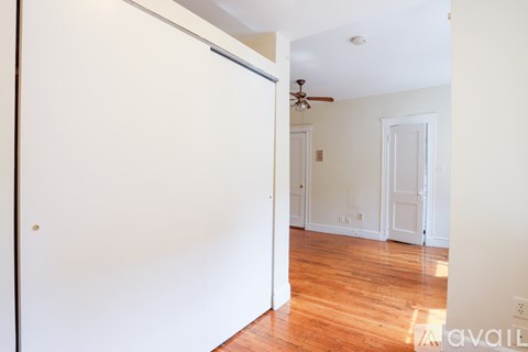 A room with a wooden floor and a ceiling fan.