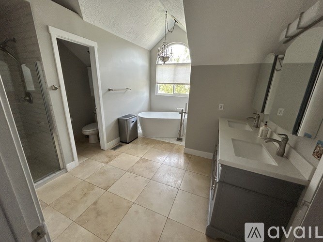 A bathroom with a toilet, sink, and bathtub.