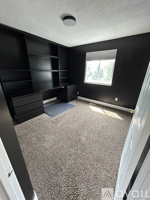 A room with black walls and a window.