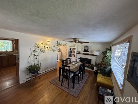 A living room with a dining table and chairs.