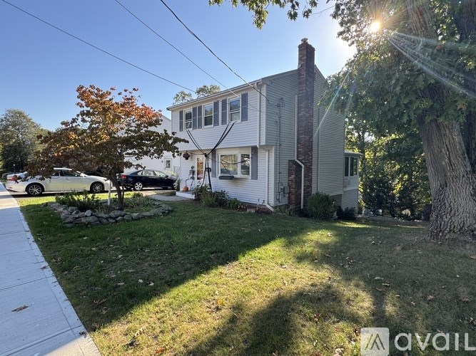 A house with a white car parked in front.