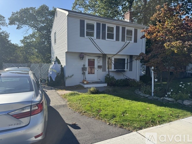 A house with a car parked in front of it.