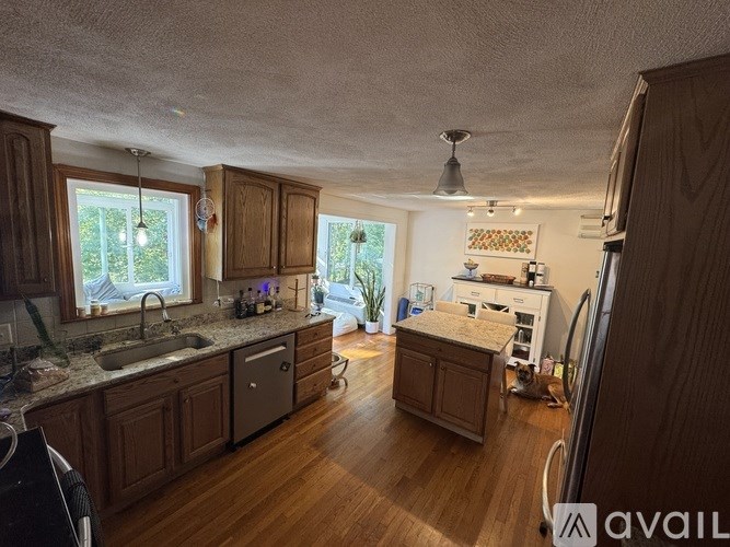 A kitchen with wooden cabinets and a sink.
