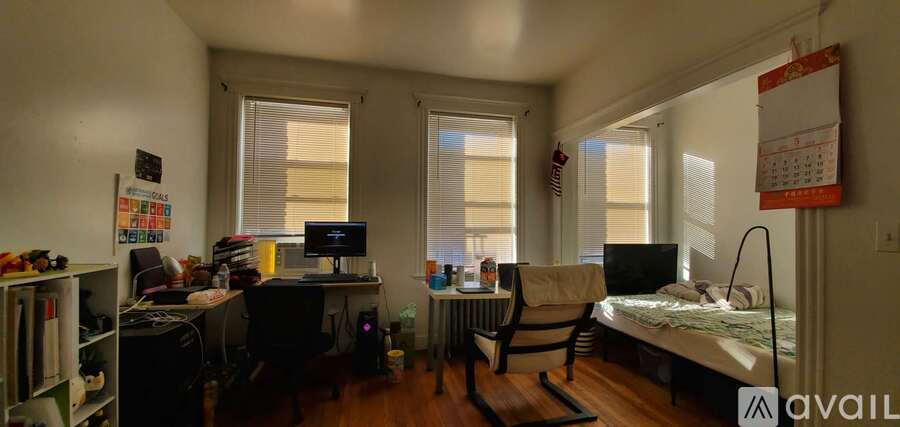 A small room with a bed, desk, and chair.