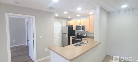 A kitchen with a countertop and a refrigerator.