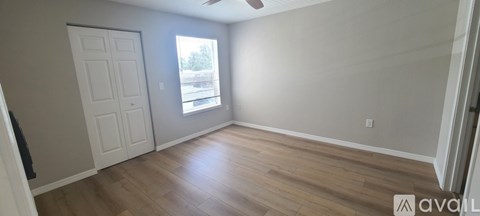 A room with wooden floors and a white door.