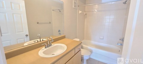A bathroom with a sink, toilet, and bathtub.