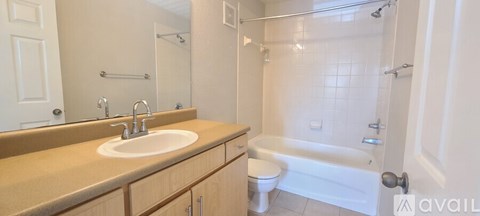 A bathroom with a sink, toilet, and bathtub.