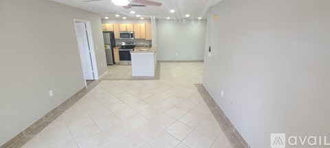 A spacious kitchen with a white island in the middle.
