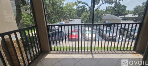 A balcony with a view of a parking lot.