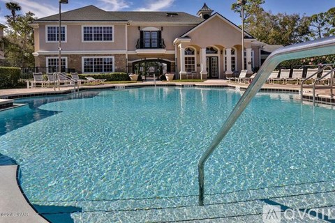 A large house with a pool in front.