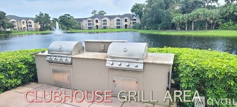 A grill area is located next to a body of water.