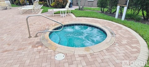 A small round pool with a metal ladder.