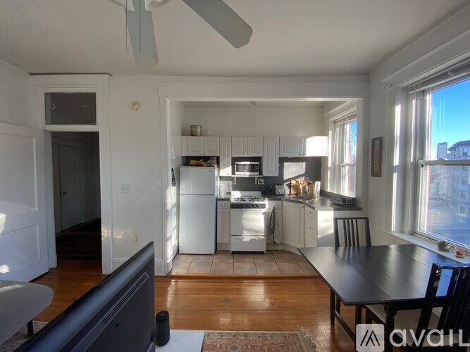 A kitchen with a refrigerator, stove, and sink.