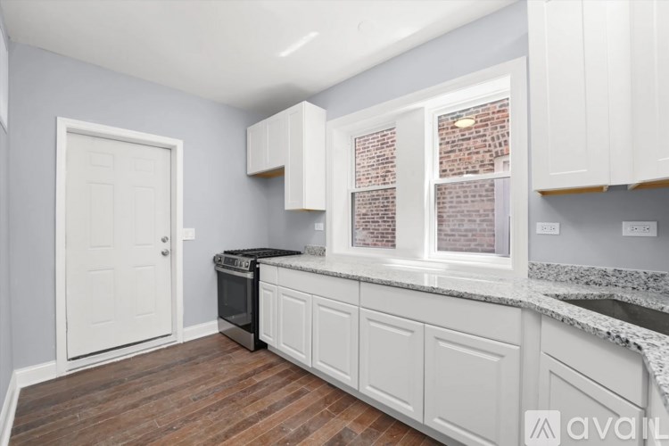 A kitchen with a white door and a black oven.