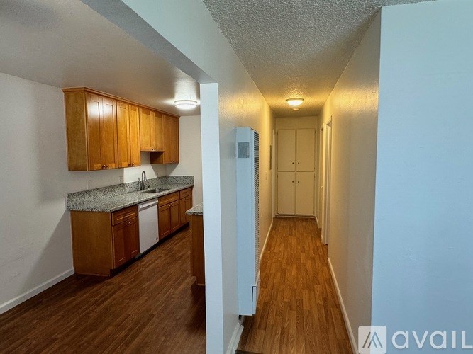 A kitchen with wooden cabinets and a countertop is visible.