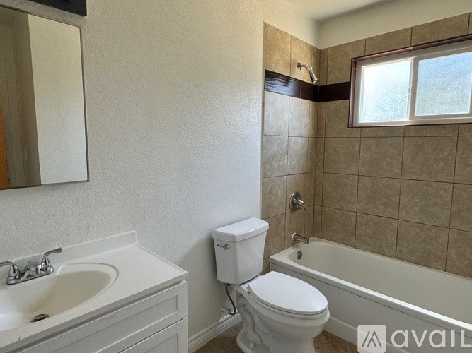 A bathroom with a toilet, sink, and bathtub.