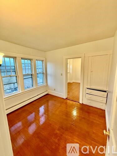 A room with wooden floors and white walls.