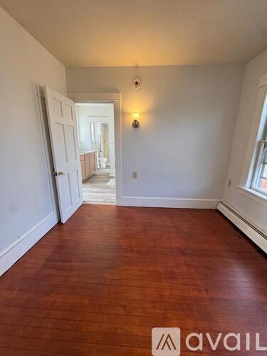 A room with wooden floors and white walls.
