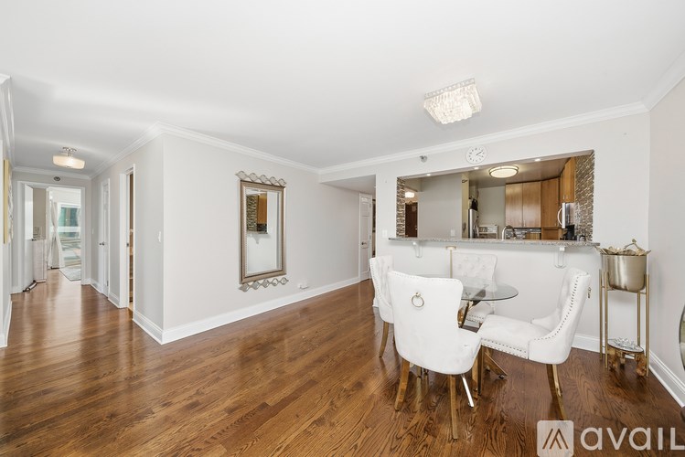 A spacious room with a dining table and chairs.