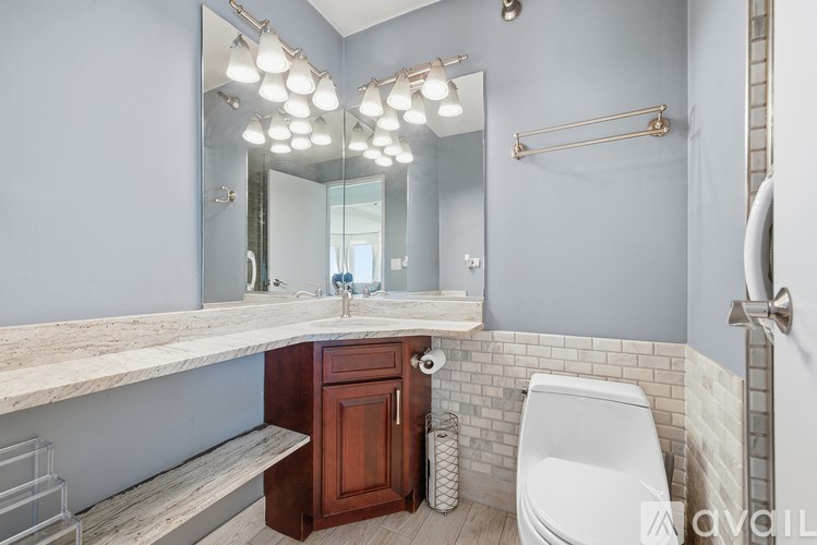A bathroom with a marble countertop and a white toilet.