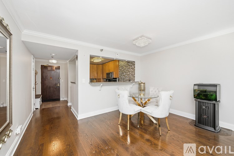A living room with a white sofa set and a fish tank.