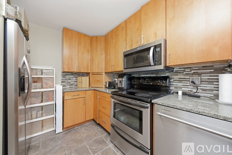 A kitchen with wooden cabinets and stainless steel appliances.