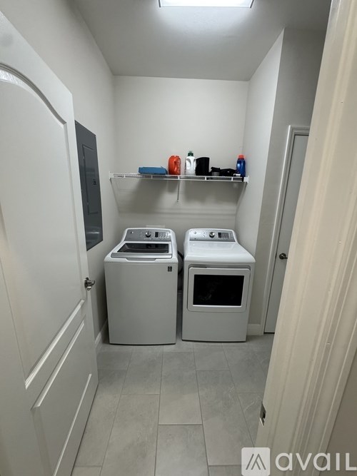 A small laundry room with a washer and dryer.