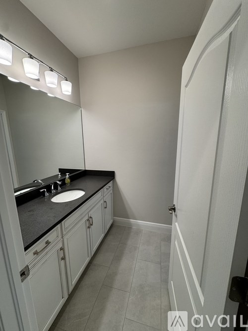A bathroom with a sink and mirror.