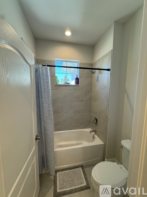 A bathroom with a toilet, tub, and shower.