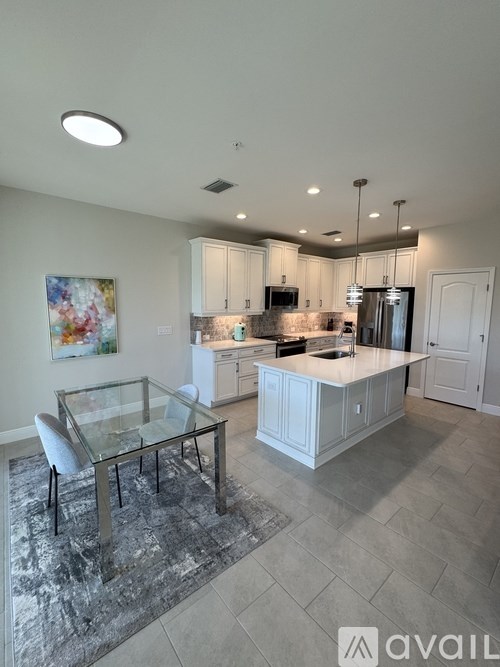 A modern kitchen with a glass table and chairs.
