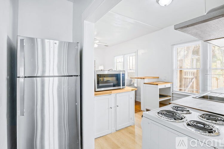 A kitchen with a stainless steel refrigerator and stove.