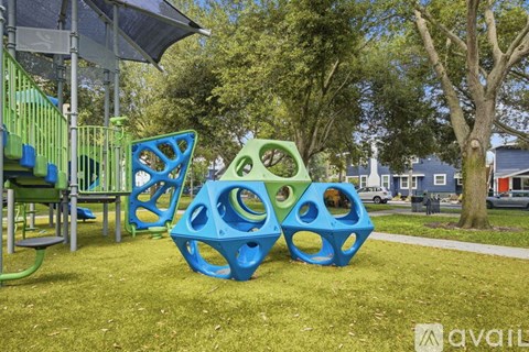 A playground with blue and green play structures.