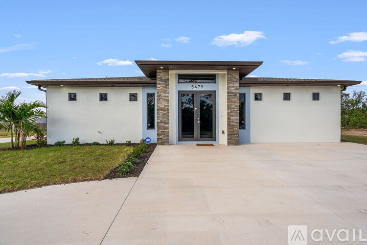 A modern house with a flat roof and a garage door.