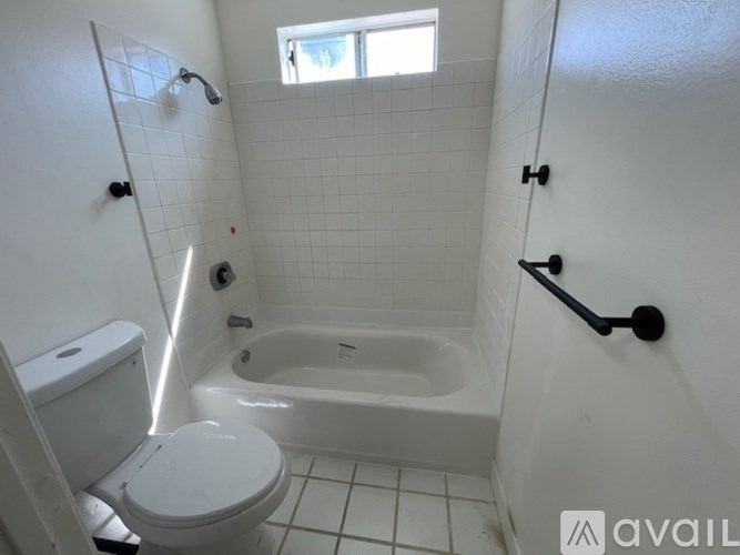 A white toilet is next to a bathtub in a bathroom.