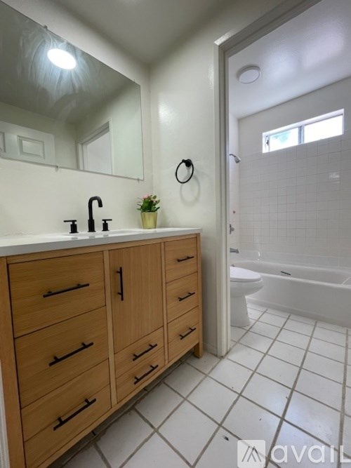 A bathroom with a vanity and a toilet.