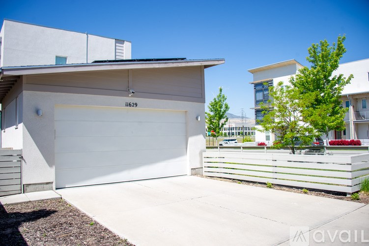 A modern house with a white garage door and number 11629 on it.