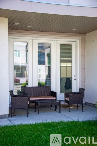 A patio with a bench and chairs.