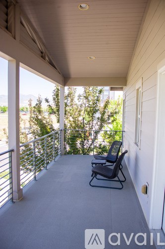 A balcony with a chair and a railing.
