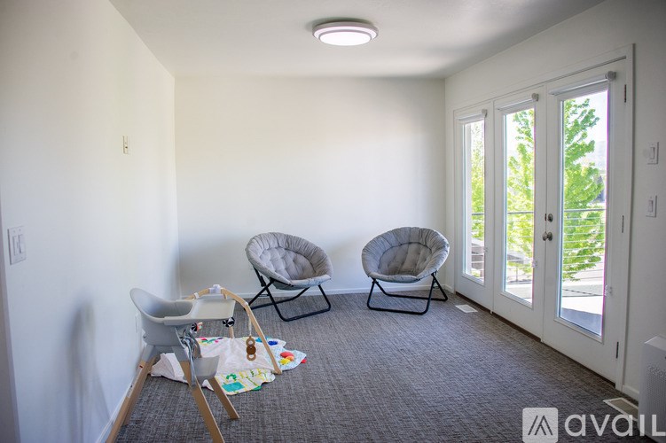 A room with two chairs and a table with art supplies on it.