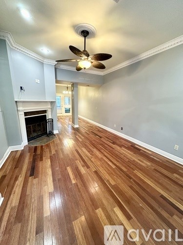 A room with wooden floors and a fireplace.