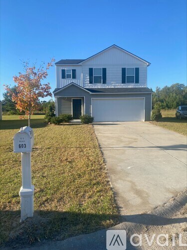 A two-story house with a garage is numbered 603.