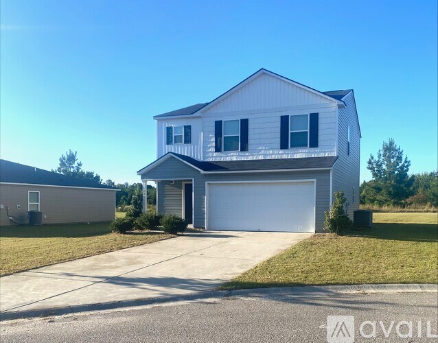 A two-story house with a garage is available for sale.
