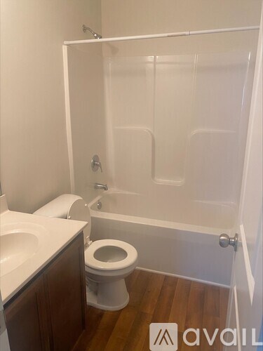 A bathroom with a toilet, sink, and shower.