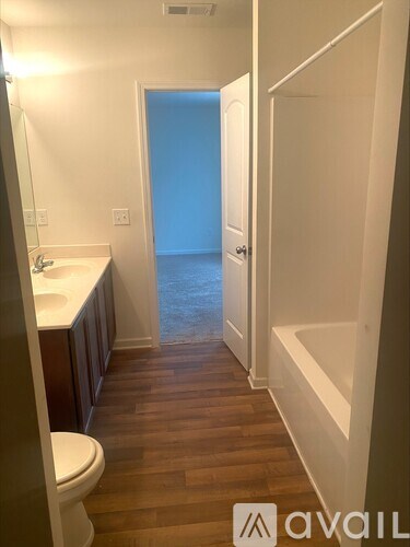 A bathroom with a toilet, sink, and bathtub.