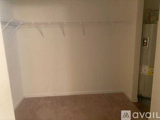 A room with a carpeted floor and a white wall with a white door.